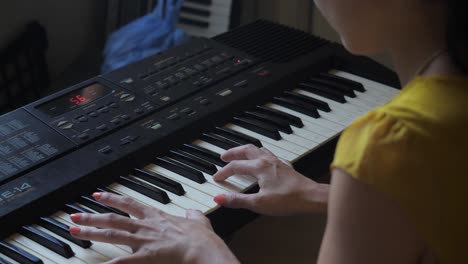 Long,-Ultra-High-Definition,-slow-motion-shot-of-an-Asian-woman-practicing-on-a-keyboard