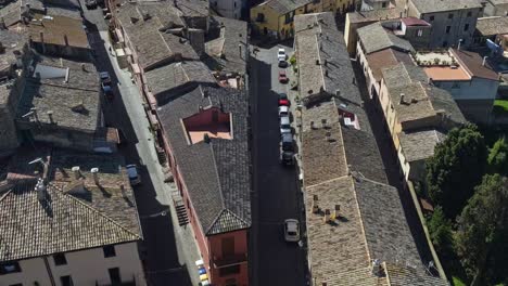 Aerial-over-the-town-and-buildings-of-Capodimonte-on-Lake-Bolsena,-Province-of-Viterbo,-Italy