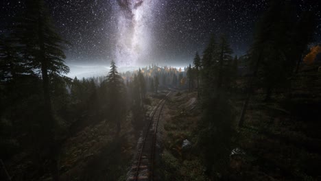 la vía láctea por encima del ferrocarril y el bosque