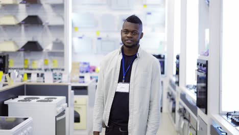 Slow-motion-video-of-a-smiling-salesman-standing-among-appliances-in-a-store