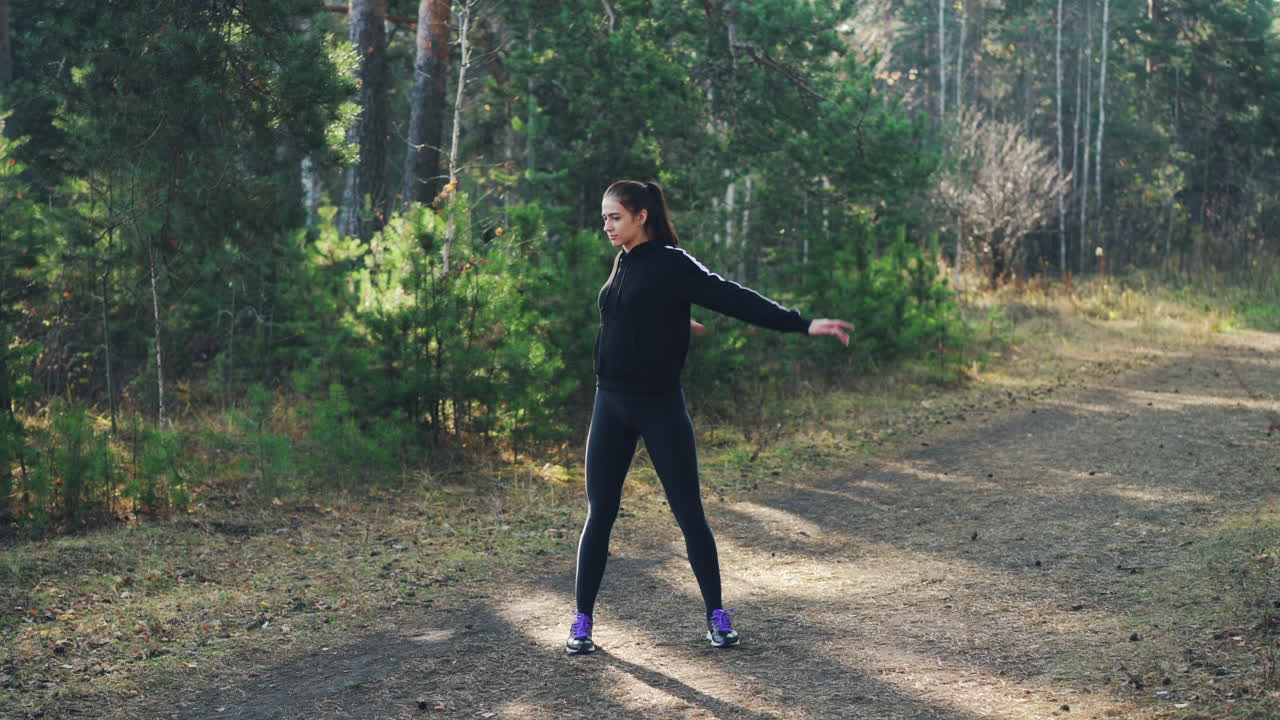 Woman Stretching Outdoors in Forest