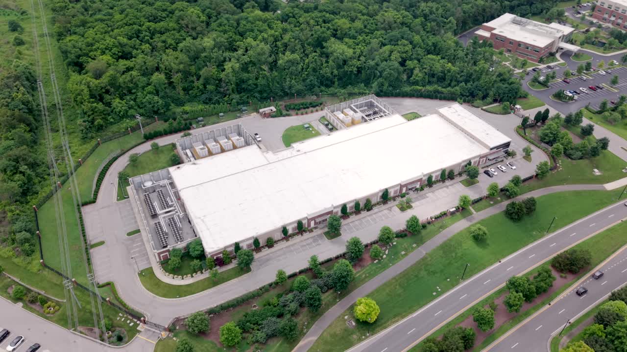 Data center facility in Nashville, Tennessee housing critical computing infrastructure such as servers, storage systems, and networking equipment for businesses - aerial orbit
