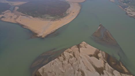 drone video capturing the narayani river winding through chitwan, nepal. showcases lush green riverbanks, flowing waters, and peaceful rural surroundings from a stunning aerial perspective