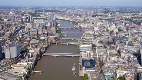 Aerial-view-of-the-River-Thames-and-bridges,-Walkie-Talkie-building-and-a-close-up-of-the-City-of-London-Towers