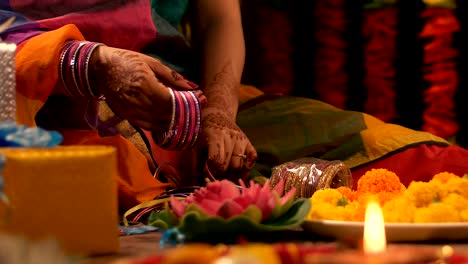 woman / female arranging bangles for her wedding celebration - festive environment