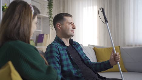 Blind-man-chatting-with-his-wife-at-home.-They-are-happy.