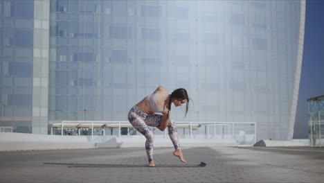 Frau-Macht-Paradiesvogel-Pose-In-Der-Stadt.-Yogatrainer-Balanciert-Auf-Einem-Bein