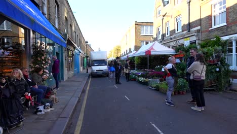 early sunday at columbia road flower market in london as vendors set up colorful flower stalls