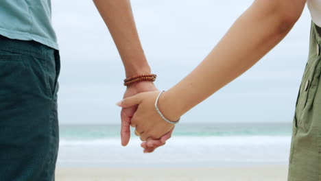 back, couple and holding hands at beach