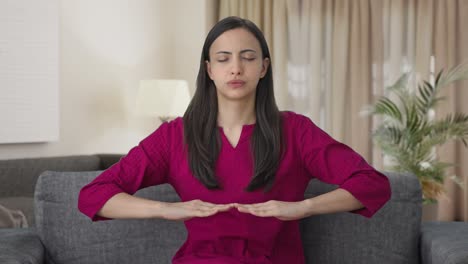 indian woman doing breathe in breathe out exercise