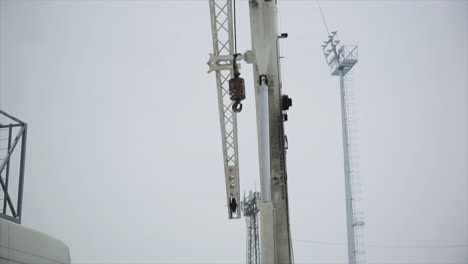 large white crane at construction site