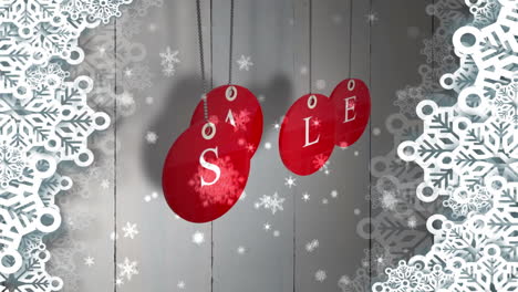 Red-sale-tags-hanging-against-wood-with-festive-border