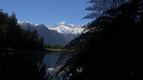 magnificent reflection of alpine mountains on clear lake - wide shot