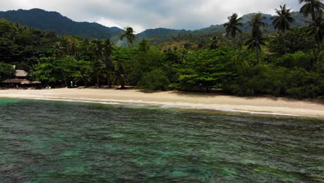 An-aerial-drone-shot-panning-a-half-orbit-of-the-Haad-Tian-beach-resort,-a-secluded-getaway-in-Koh-Tao-island-in-Surat-Thani-province,-Thailand