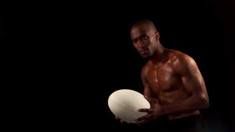 Serious-man-throwing-rugby-ball-