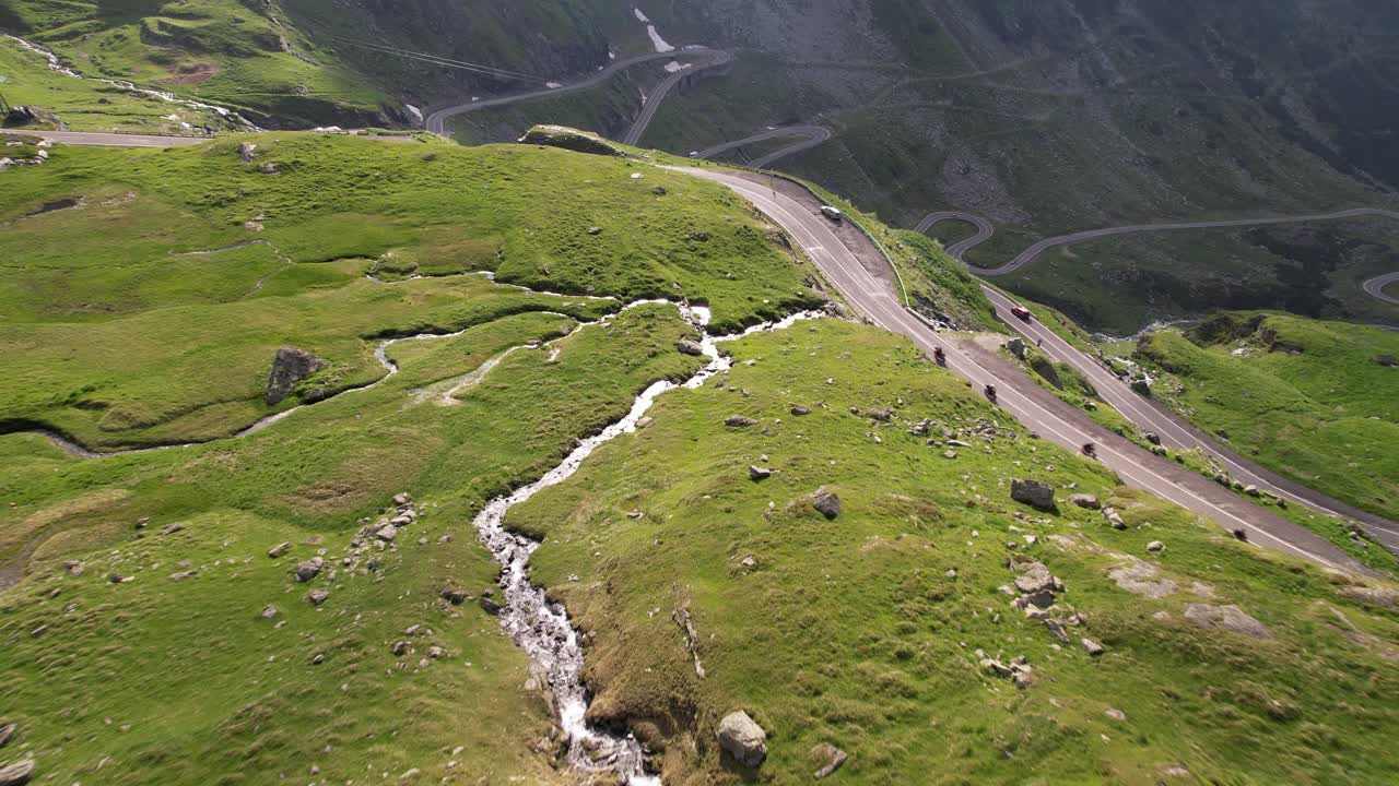 Motorcycle trip on Transfagarasan road in Carpathian Mountains Romania Cinematic drone aerial 4K video