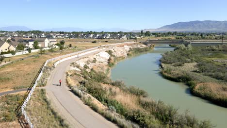 a picturesque biking trail along the jordan river in lehi, utah - aerial flyover
