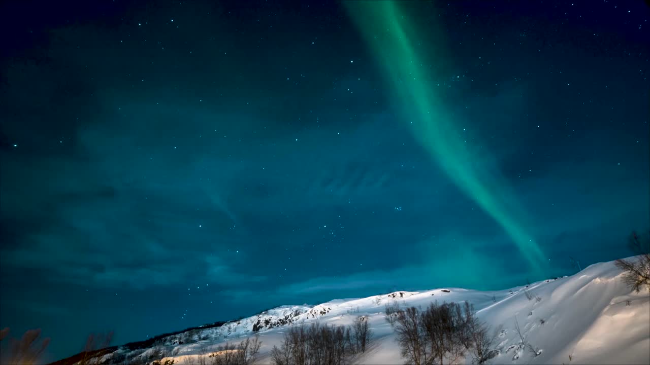 Aurora Borealis - Northern Lights Over Snowy Mountain At Winter In Lapland, Finland. - wide shot