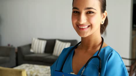 Portrait-of-female-doctor-holding-a-clipboard