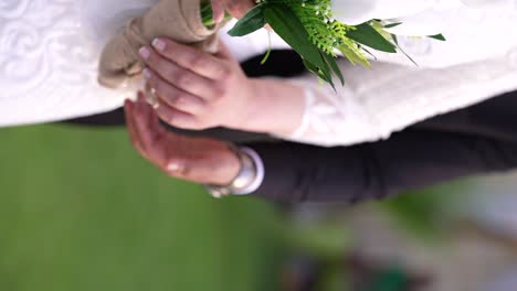 the groom and the bride are holding hand and ready for their photo session vertical video