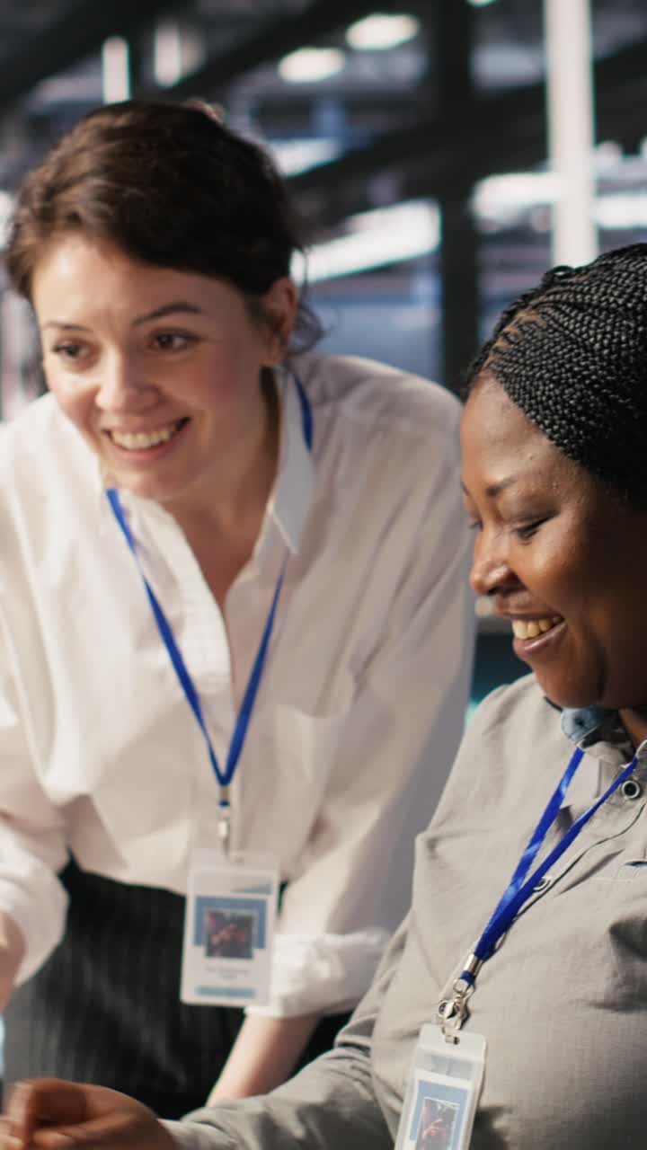 Vertical video Cheerful data center technicians collaborating on AI automation deployment