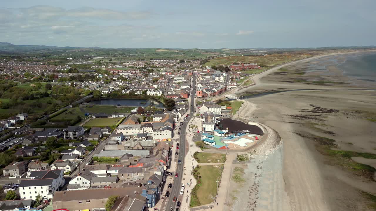 Ultrawide overhead aerial video of Newcastle Beach and Main Street in Newcastle, County Down in Northern Ireland in the UK. Filmed on a bright sunny day in 4K, 60fps and in Rec709 Color.