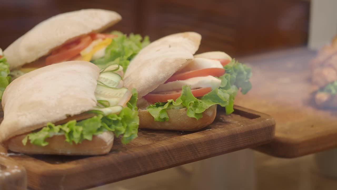 Sandwiches with fresh ingredients on a wooden board