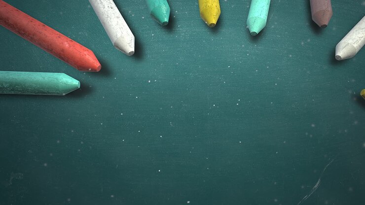 Closeup colorful chalk on blackboard school background of education theme
