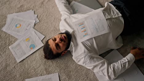 overworked businessman lying on the floor