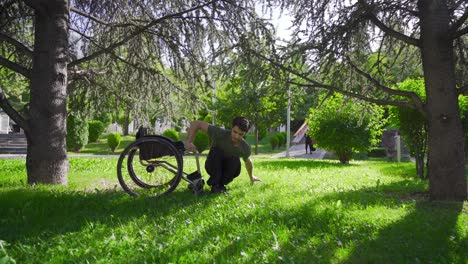 Physically-disabled-young-man-sitting-outdoors-on-the-grass.