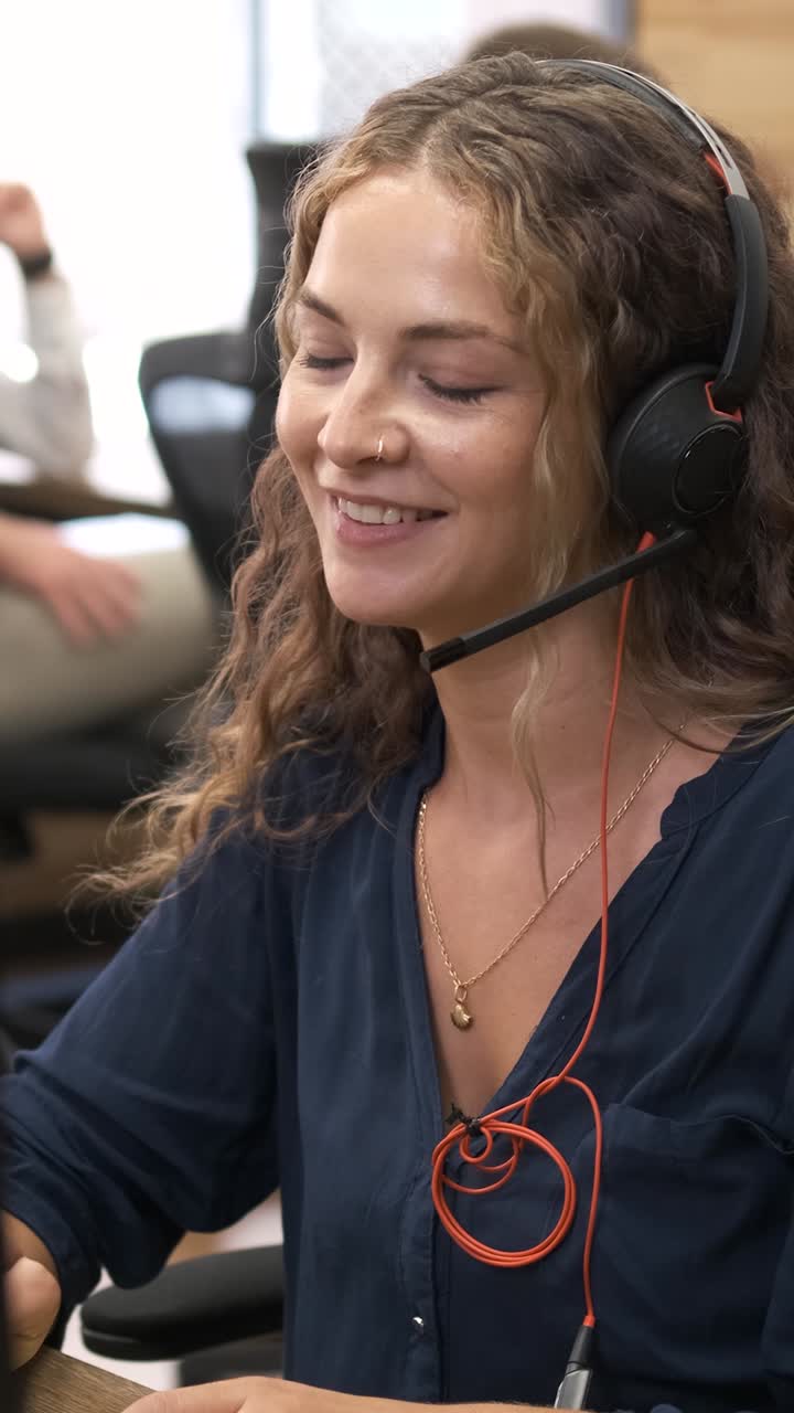 Customer service agent talking on headset. Vertical footage
