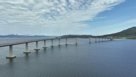 the tresfjord bridge crossing tresfjorden sea near molde in norway - summer aerial view of bridge