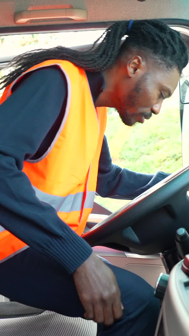 Man driving a vehicle wearing a safety vest