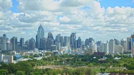 timelapse of clouds over the modern urban skyline of bangkok, thailand