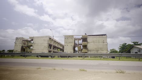 wide street view of natin building in paramaribo suriname with cars passing by