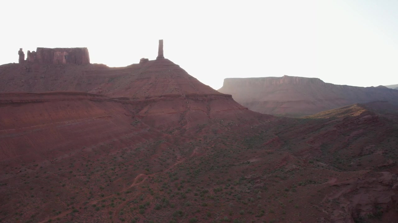 Drone in volo laterale alla Castleton Tower a Moab all'alba in 4K.