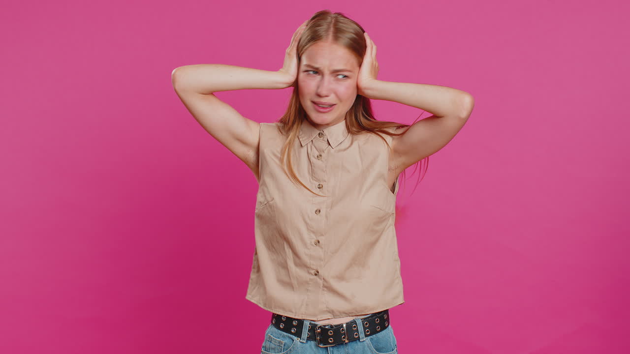 Annoyed irritated young woman covering ears gesturing no avoiding advice ignoring noise loud voices