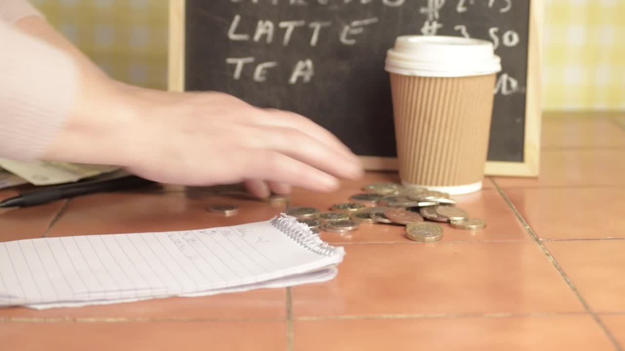 Cafe owner counting coins at close of business