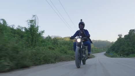 person riding motorcycle on a dirt road in the countryside