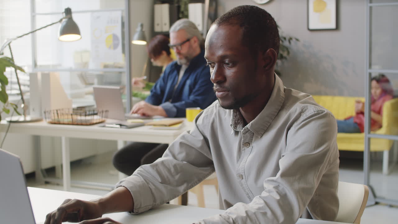 Portrait of African American Male Office Worker at Desk