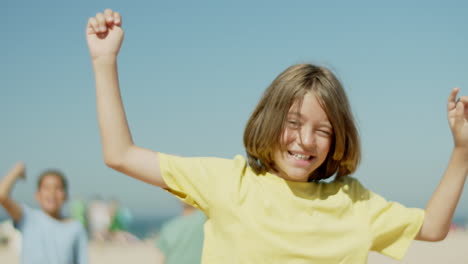 front view of happy teenage sportsman raising hands up