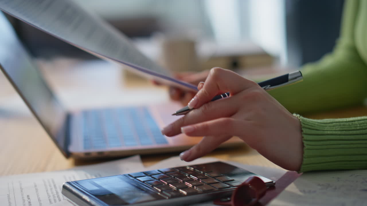 Office hand holding pen examining contract closeup. Accountant counting coasts