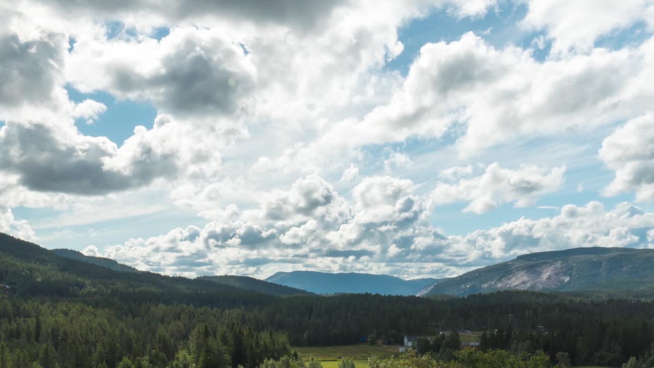 Cumulus Clouds Rolling Over Sunny Sky Of Forest And Mountains