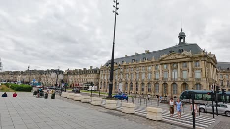 pigeon flies over historic bordeaux square