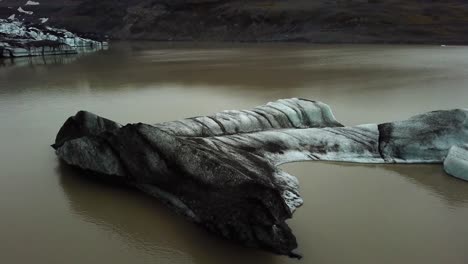 aerial view of an iceberg detached from sólheimajökull glacier, in summer, iceland