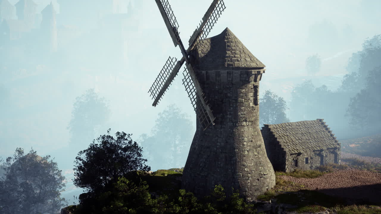 старая ветряная мельница в туманной долине