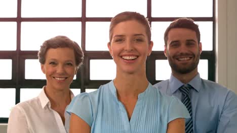 portrait of smiling business team standing with arms crossed