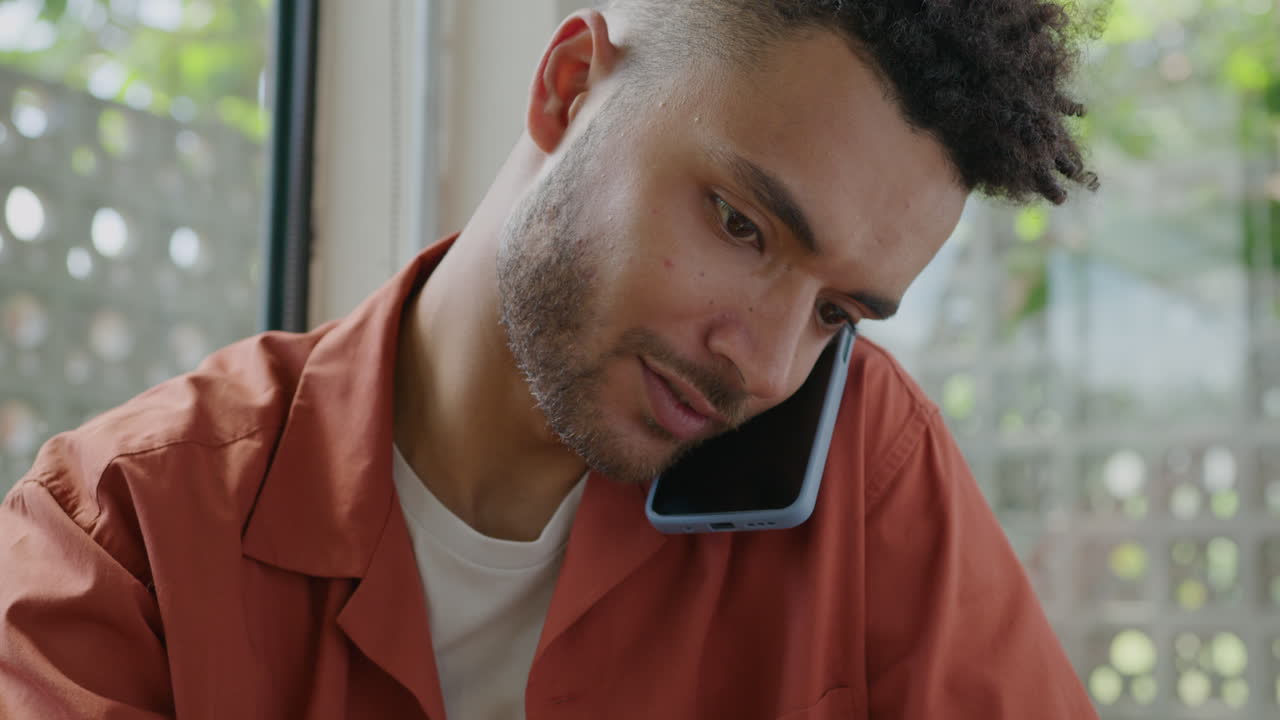 Colleagues Using Laptop during Meeting in Cafe