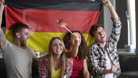 sport fans watching tv and supporting german team