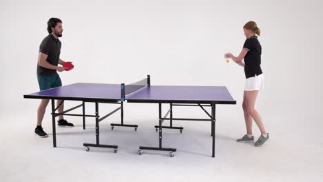 playing table tennis, man and woman competing in friendly match indoors